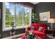Cozy sitting area with a bright window, a comfortable red chair and ottoman, and dark walls at 2354 Valelake Rd, York, SC 29745
