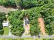 An aerial view of the property showcasing its lush surroundings, tree coverage, and proximity to the lake at 248 Pioneer Dr, Mount Gilead, NC 27306