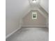Finished attic space with neutral paint, carpet flooring, natural light, and storage doors at 248 Pioneer Dr, Mount Gilead, NC 27306