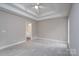 Large bedroom with plush carpet and a tray ceiling at 248 Pioneer Dr, Mount Gilead, NC 27306