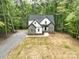Exterior view of the home featuring its gray roof, stone and siding combination, and landscaped front yard at 248 Pioneer Dr, Mount Gilead, NC 27306