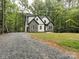Charming home with stone and siding exterior, surrounded by mature trees and a gravel driveway at 248 Pioneer Dr, Mount Gilead, NC 27306