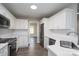 Modern kitchen featuring white cabinets, stainless steel appliances, and white subway tile backsplash at 248 Pioneer Dr, Mount Gilead, NC 27306