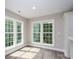 Bright living room features large windows and wood-look floors at 248 Pioneer Dr, Mount Gilead, NC 27306