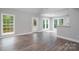 Sunlit living room featuring hardwood floors, neutral paint, and access to the outdoor patio at 248 Pioneer Dr, Mount Gilead, NC 27306