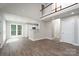 Spacious living room with new hardwood floors and an open view into the kitchen area at 248 Pioneer Dr, Mount Gilead, NC 27306