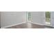 Neutral room featuring hardwood floors, white trim, light gray walls, and a patio door for natural light at 248 Pioneer Dr, Mount Gilead, NC 27306