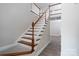 Elegant staircase featuring carpeted treads and white wood railing at 248 Pioneer Dr, Mount Gilead, NC 27306