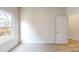 A vacant carpeted bedroom filled with natural light through a window and equipped with a door to the hallway at 2547 Ruby Dixon Crossing Dr # 17, Gastonia, NC 28056