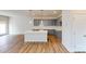 An open-concept kitchen features an island, gray cabinets, and wood floors at 2547 Ruby Dixon Crossing Dr # 17, Gastonia, NC 28056
