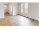 A bright living room features hard surface floors and large windows offering plenty of natural light at 2547 Ruby Dixon Crossing Dr # 17, Gastonia, NC 28056