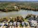 Stunning aerial view of lakeside homes surrounded by lush trees in a vibrant, serene community at 25566 Seagull Dr, Lancaster, SC 29720