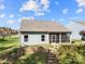 Backyard featuring a screened porch and gentle slope with retaining wall and steps at 25566 Seagull Dr, Lancaster, SC 29720