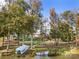 Expansive backyard leading to the lake with a covered boat dock and lush mature trees at 25566 Seagull Dr, Lancaster, SC 29720