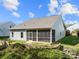 Backyard featuring a screened porch, steps and a well-maintained lawn at 25566 Seagull Dr, Lancaster, SC 29720