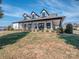 Spacious clubhouse exterior with covered porch, black trim and professional landscape on a sunny day at 25566 Seagull Dr, Lancaster, SC 29720