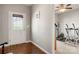 Entryway featuring hardwood floors, a white door with windows, and view of a room with exercise equipment at 25566 Seagull Dr, Lancaster, SC 29720