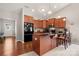 Spacious kitchen featuring wood cabinets, granite countertops, and a functional island with seating at 25566 Seagull Dr, Lancaster, SC 29720