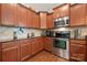 Beautiful kitchen showcasing stainless steel appliances, granite countertops, and rich wood cabinetry at 25566 Seagull Dr, Lancaster, SC 29720