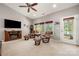 Bright living room with vaulted ceiling, fireplace, plush seating, and door to a covered outdoor space at 25566 Seagull Dr, Lancaster, SC 29720