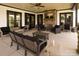 A cozy outdoor porch features ample seating, a stone fireplace, and elegant dark trim at 25566 Seagull Dr, Lancaster, SC 29720