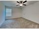 Bright bedroom with plush carpeting, a modern ceiling fan, and natural light from a window at 2620 Poplar Cove Nw Dr, Concord, NC 28027