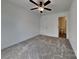Bedroom featuring neutral carpet, ceiling fan, and a view of an ensuite bathroom at 2620 Poplar Cove Nw Dr, Concord, NC 28027