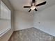 Sunlit bedroom with cozy carpet, a modern ceiling fan, and a large window at 2620 Poplar Cove Nw Dr, Concord, NC 28027