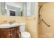 Bathroom featuring a wood vanity, a toilet, a walk-in shower, and a vanity mirror at 2631 Ivey Church Rd, Lincolnton, NC 28092