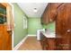 Cozy laundry room with green walls, granite countertops, and a washer and dryer set at 2631 Ivey Church Rd, Lincolnton, NC 28092
