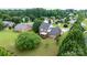 Backyard aerial view shows a brick home, lush greenery, and neighborhood setting at 2779 Touchstone Cir, Newton, NC 28658