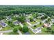 Aerial view displays neighborhood with lush greenery and mature trees throughout property lines at 2779 Touchstone Cir, Newton, NC 28658