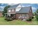 Exterior of brick home featuring a covered porch, air conditioning units, and a lush lawn at 2779 Touchstone Cir, Newton, NC 28658