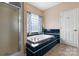 Bathroom with a tiled tub, separate shower, and window for natural light at 2779 Touchstone Cir, Newton, NC 28658