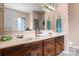 Bathroom with double sink vanity, framed mirror, and natural light from window at 2779 Touchstone Cir, Newton, NC 28658