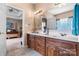 Bathroom with double sinks, wood cabinets, and natural light from a window at 2779 Touchstone Cir, Newton, NC 28658