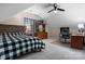 Spacious bedroom featuring neutral carpeting, ceiling fan, and a dedicated desk area for a functional workspace at 2779 Touchstone Cir, Newton, NC 28658