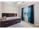 Bedroom with bed frame, built-in storage, and a window with blue curtains at 2779 Touchstone Cir, Newton, NC 28658