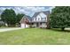 Charming two-story brick home with a covered front porch and a well manicured front lawn at 2779 Touchstone Cir, Newton, NC 28658