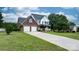 Beautifully landscaped home featuring a lush lawn, mature trees, and a long driveway at 2779 Touchstone Cir, Newton, NC 28658