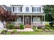 Inviting covered front porch with decorative wreath, charming landscaping, and seating for relaxing at 2779 Touchstone Cir, Newton, NC 28658