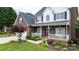 Inviting covered front porch with decorative wreath, charming landscaping, and seating creates a welcoming entrance at 2779 Touchstone Cir, Newton, NC 28658