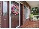 Charming front porch featuring a decorative wreath on the door and a rocking chair at 2779 Touchstone Cir, Newton, NC 28658
