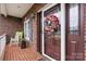 Charming front porch featuring a decorative wreath on the door and a rocking chair at 2779 Touchstone Cir, Newton, NC 28658