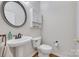 Bathroom features a pedestal sink, white toilet, decorative mirror, and vanity storage at 3725 Leela Palace Way, Fort Mill, SC 29708