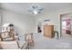 Bright bedroom featuring carpet floors, two chairs, a doll house, and a ceiling fan at 3725 Leela Palace Way, Fort Mill, SC 29708