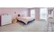 Lovely pink bedroom featuring carpet floors, a queen bed, two windows, and charming decor at 3725 Leela Palace Way, Fort Mill, SC 29708
