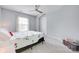 Cozy bedroom with carpet floors, a floral-themed bed, a ceiling fan, and a window for natural light at 3725 Leela Palace Way, Fort Mill, SC 29708
