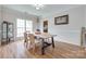 Sunlit dining area features hardwood floors, modern lighting, and ample seating at 3725 Leela Palace Way, Fort Mill, SC 29708