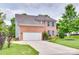 Traditional two-story brick home with a well-maintained lawn, manicured landscaping and attached two car garage at 3725 Leela Palace Way, Fort Mill, SC 29708